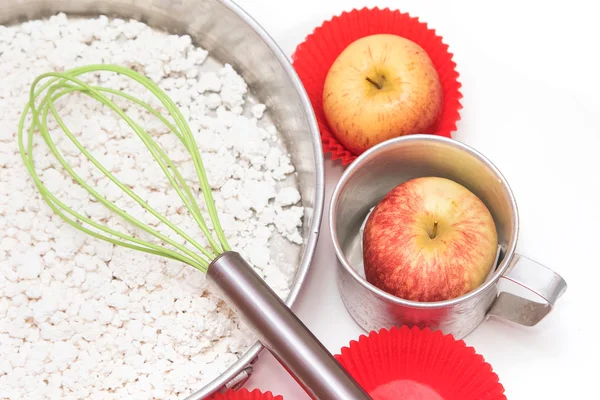 Ingredients and tools to make a cake, flour, apple and sugar