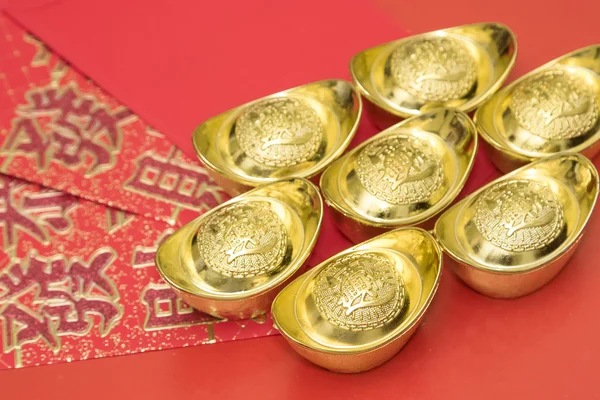 Gold ingots on red envelope of China in the Chinese New Year fes