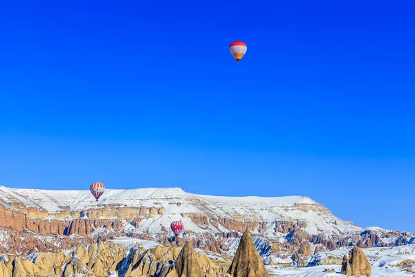 Flying balloons over mountains. Capadocia. Turkey.