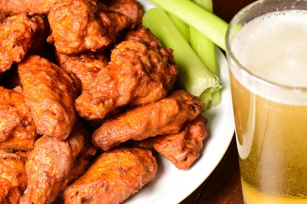 Buffalo Wings with Celery Sticks and Beer