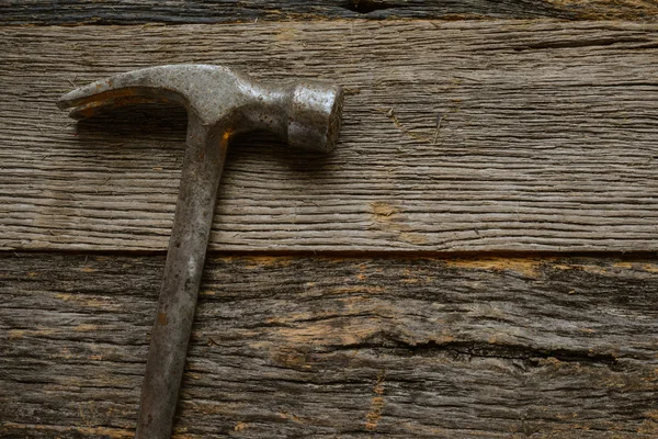 Hammer on rustic hardwood floor