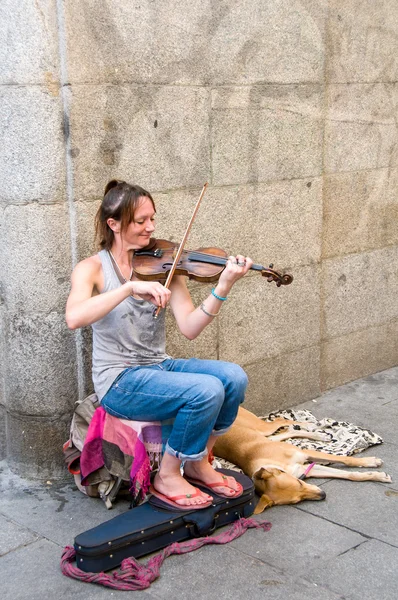 : The unknown woman plays a violin for money on the street,