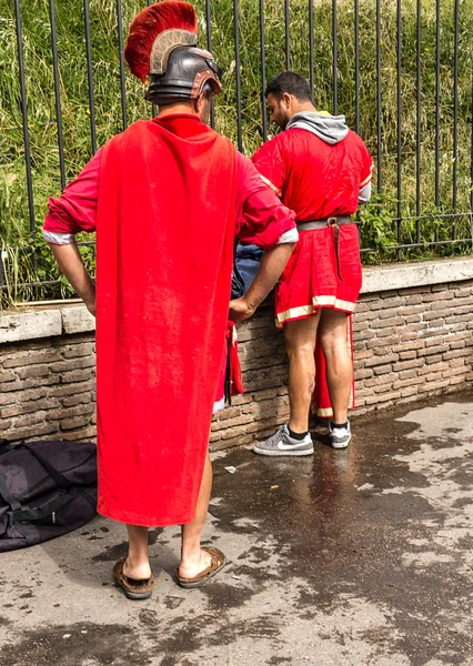 Roman warrior actors changing clothes on a street in Rome