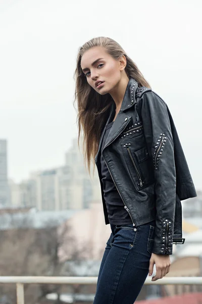 Girl in leather jacket on a rooftop