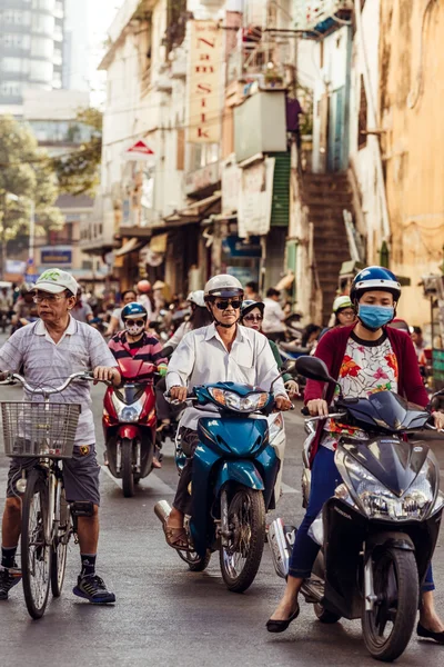 HO CHI MINH, VIETNAM - JAN 15, 2016: Architecture and motorbikes traffic on the street in Hochiminh (Saigon) on the sunset. Saigon is the largest city in Vietnam