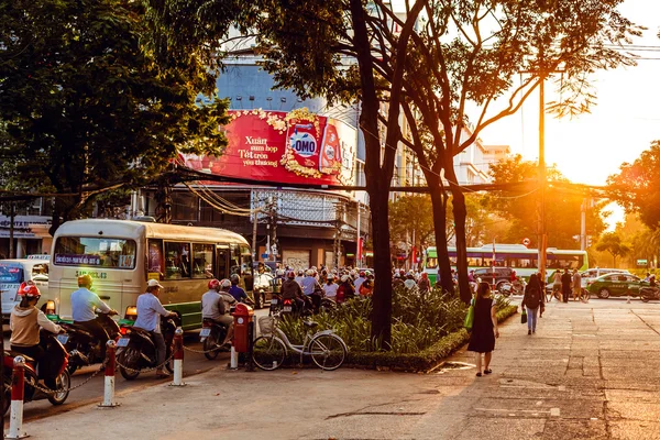 HO CHI MINH, VIETNAM - JAN 14, 2016: Architecture and motorbikes traffic on the street in Hochiminh (Saigon) on the sunset. Saigon is the largest city in Vietnam