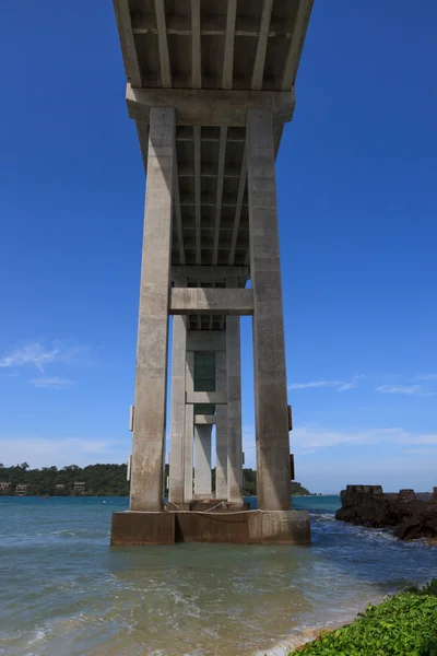 Tropical seascape with a high bridge to an island