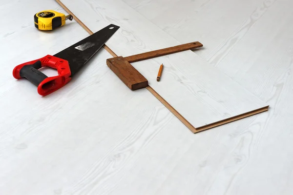 Tools for cutting laminate floor board