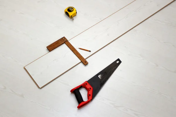 Tools for cutting laminate floor board, concept of home improvements process