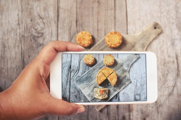 Taking a photo of festival moon cake with smart phone