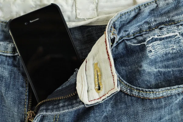 Smart phone in jeans pocket