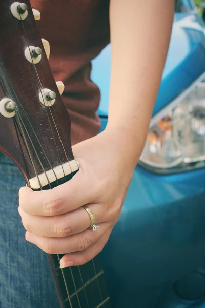 Young woman playing the guitar