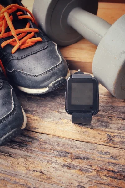 Sports set of sneakers , dumbbells and smartwatch