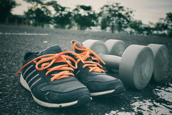 Sports set of sneakers with dumbbells