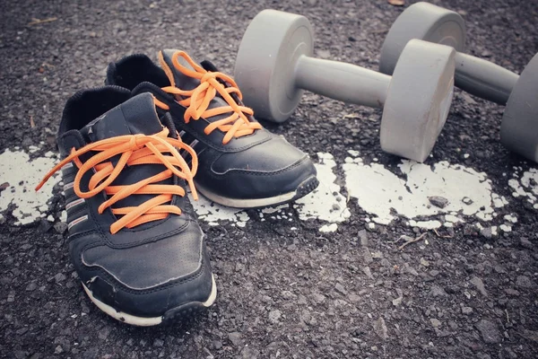 Sports set of sneakers with dumbbells