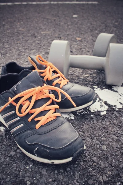 Sports set of sneakers with dumbbells