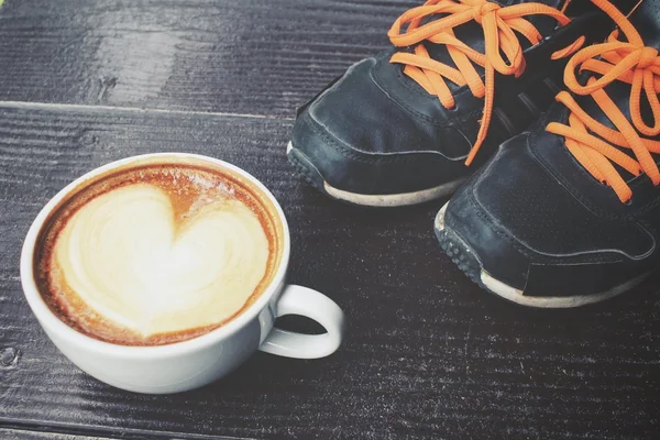 Vintage latte art coffee with sneakers