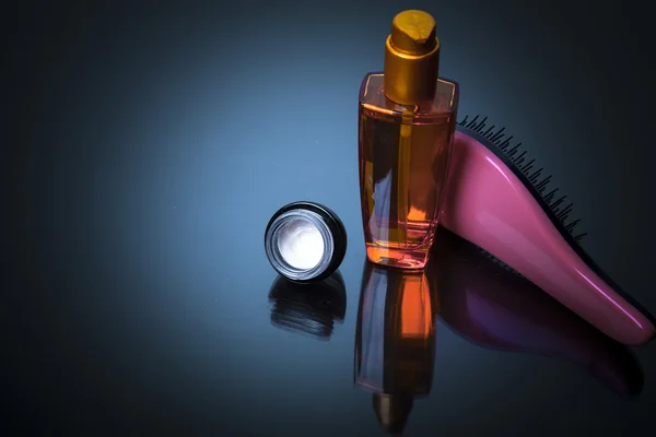 Various bottles of health and beauty products and hair brush