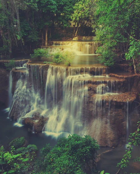 Tropical rainforest waterfall in Thailand. Retro filtered color