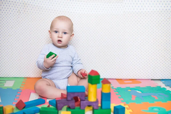 Child plays with toy blocks