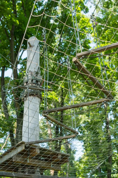 The bridge of logs tied to the ropes, part of a ropes course