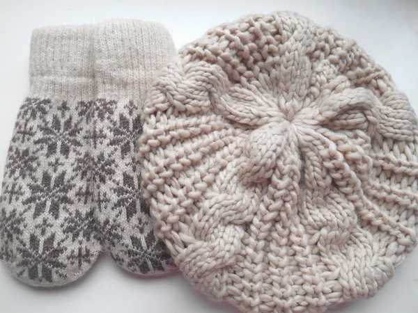 Set of  beige mittens and hat on a white background