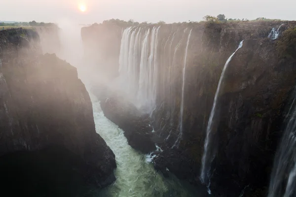 Victoria Falls from Zambia side at dusk with mist