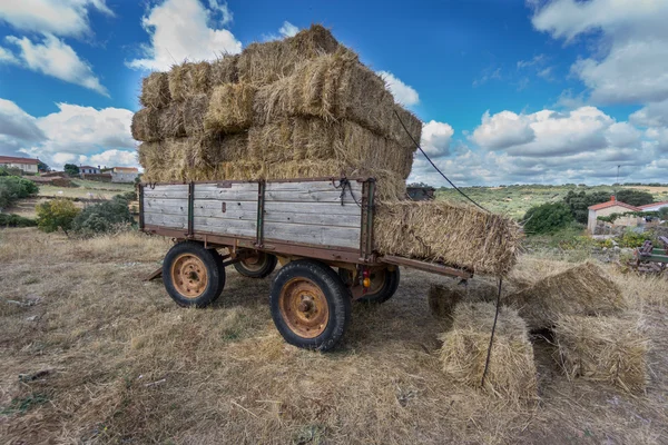 Vintage tractor trailer fully loaded with bales of hay