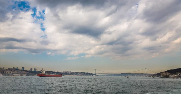 Bosphorus with buildings, bridge and cargo ship, Istanbul