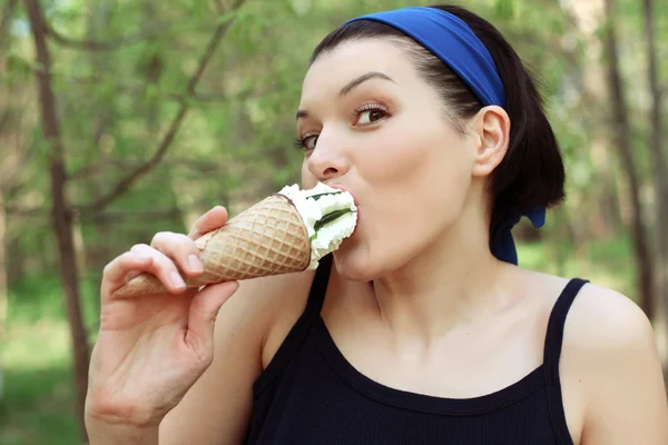 Ice cream. Cute and cheerful woman with ice cream in hand. Tasty