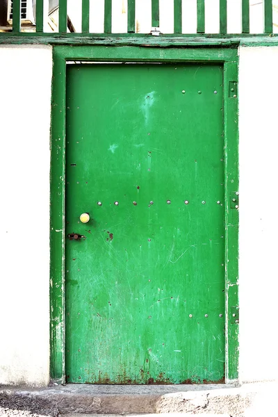 Metallic green door in Tbilisi, Georgia. Vertical