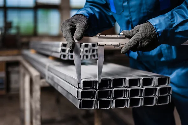 Worker measures the metal profile