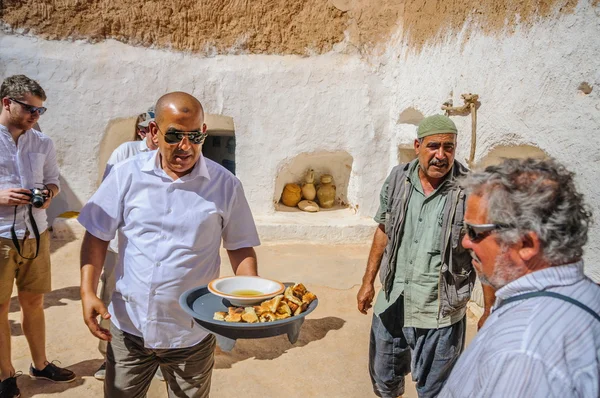 HAMMAMET, TUNISIA - Oct 2014: Man is feeding with cake and honey on October 7, 2014