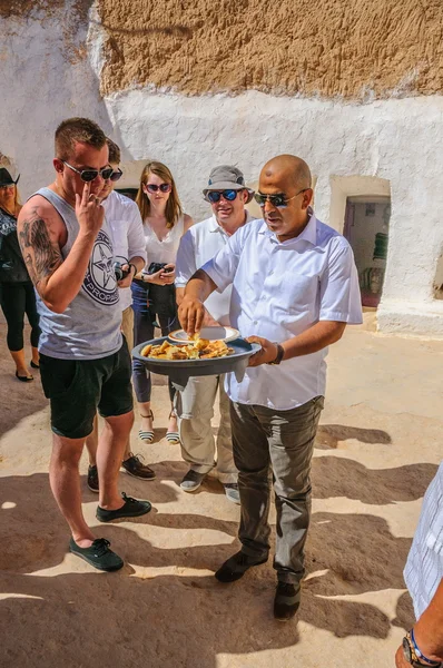 HAMMAMET, TUNISIA - Oct 2014: Man is feeding with cake and honey on October 7, 2014