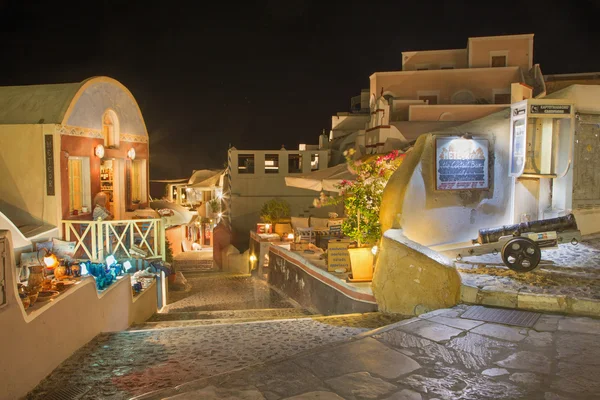 SANTORINI, GREECE - OCTOBER 4, 2015: The street of Oia with the souvenirs shops and restaurants at night.
