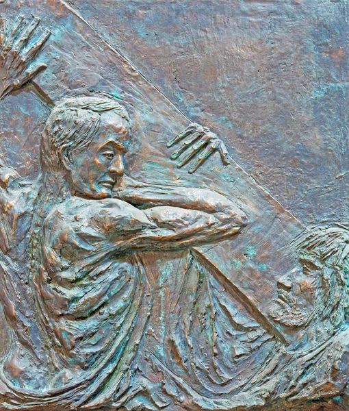 ROME, ITALY - MARCH 25, 2015: The Simon of Cyrene helps Jesus carry the cross bronze relief by Fernando Mario Paonessa (2000) in church Basilica dei Santi Ambrogio e Carlo al Corso.