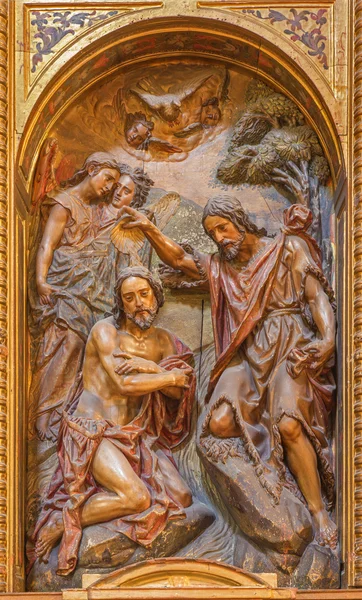 SEVILLE, SPAIN - OCTOBER 29, 2014: The carved polychrome relief of the Baptism of Christ in church Iglesia de la Anunciacion by Martinez Montanes from 18. cent.