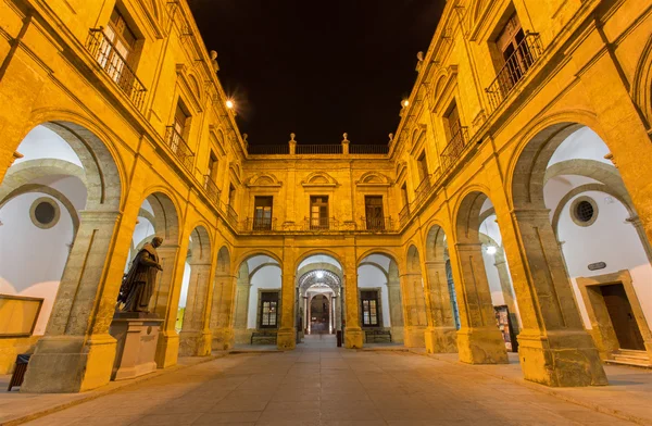 Seville - The atrium of University fromer Tobacco Factory at night.
