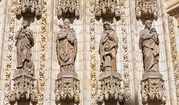 SEVILLE, SPAIN - OCTOBER 28, 2014: The statues of holys on the main west portal (Puerta de la Asuncion) of Cathedral de Santa Maria de la Sede from neo gothic restoration in years 1883 - 1898.