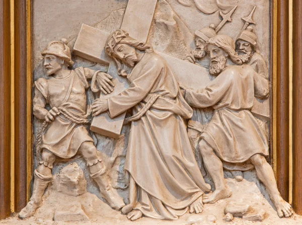 VIENNA, AUSTRIA - DECEMBER 17, 2014: Simon of Cyrene help Jesus to carry his cross. Relief as one part of Cross way cycle in Sacre Coeur church by R. Haas from end of 19. cent.