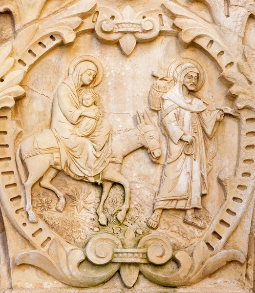 BETHLEHEM, ISRAEL - MARCH 6, 2015: The flight of Holy family to Egypt. The relief on the portal in chapel of  \