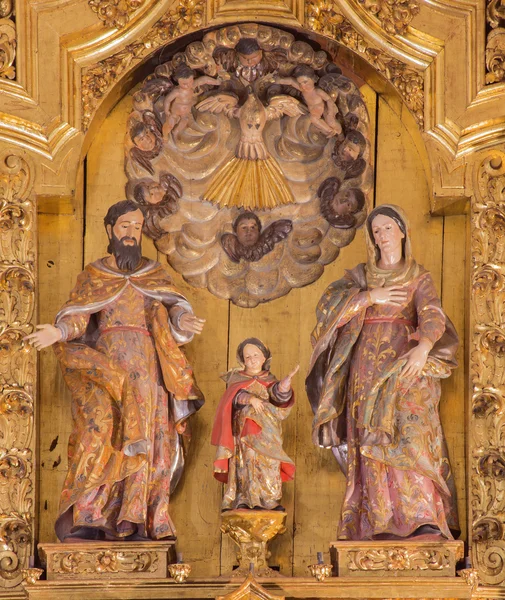 CORDOBA, SPAIN - MAY 26, 2015: The carved Holy Family sculptural group on the main altar in church of Monastery of st. Ann and st.Joseph (Convento de Santa Ana y San Jose) by Sanchez de Rueda (1710).