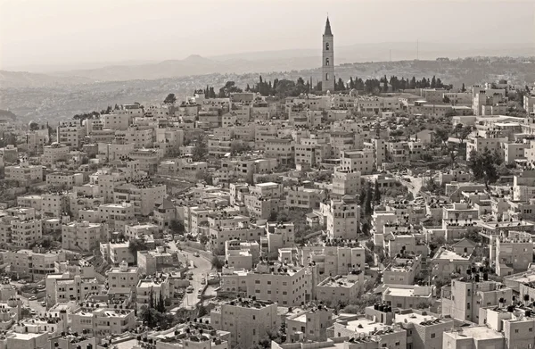 Jerusalem - The Russian orthodox church of Ascension on the Mount of Olives and the ruins of Herodion on the horizon.