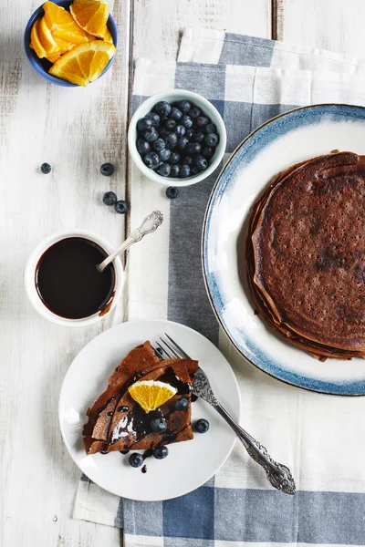 Chocolate crepes with blueberries and orange