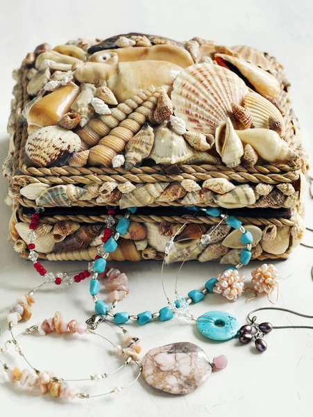 Collection of jewelry in jewelry box decorated with seashells