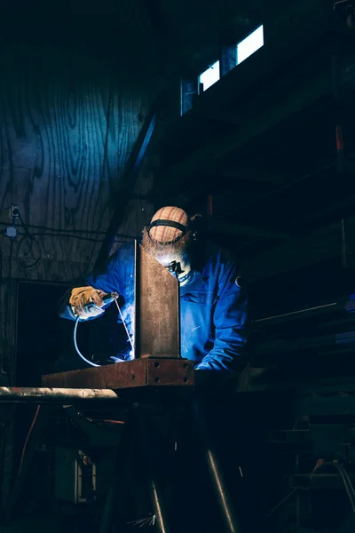 Man in welding mask working