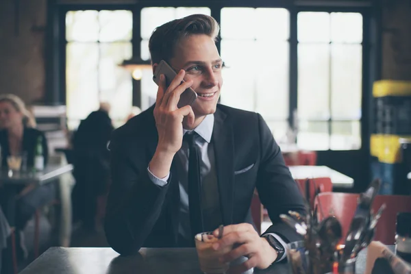 Smiling young businessman calling