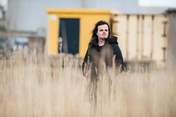 Androgynous man in field