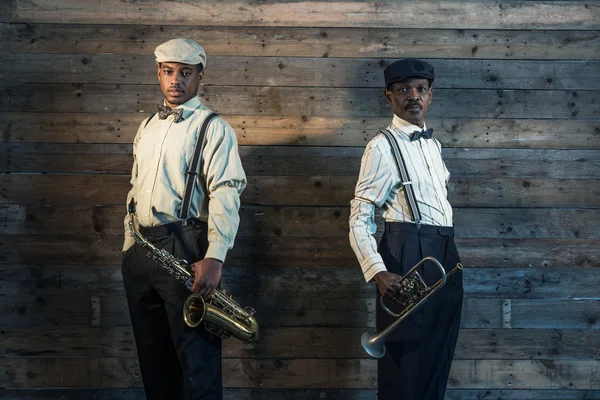 Two african american jazz musicians with trumpet and saxophone s