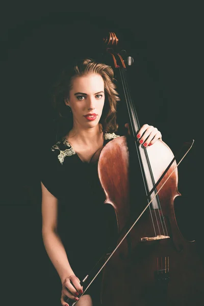 Woman Holding a Cello Instrument